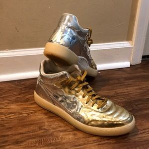 Gold and chrome Nike basketball shoes